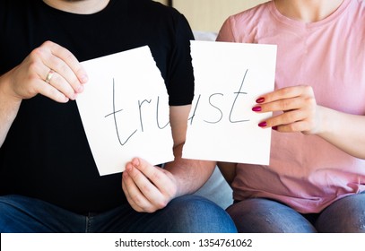 No trust. Cheating, infidelity, marital problems, having an affair and another partner, betrayal, mistrust or being unfaithful concept. Couple, man and woman, ripping same paper.  - Shutterstock ID 1354761062