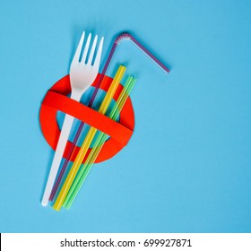 No use symbol in red with plastic straws and fork on blue background.  Plastic pollution is harmful to  marine lives including turtle, shark and whale. Environmental concept. Ban single use plastic.