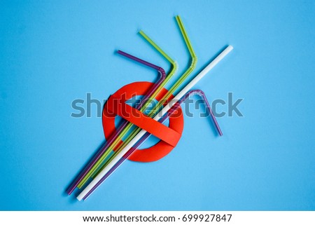 No use symbol in red with plastic straws and fork on blue background.  Plastic pollution is harmful to  marine lives including turtle, shark and whale. Environmental concept. Ban single use plastic.