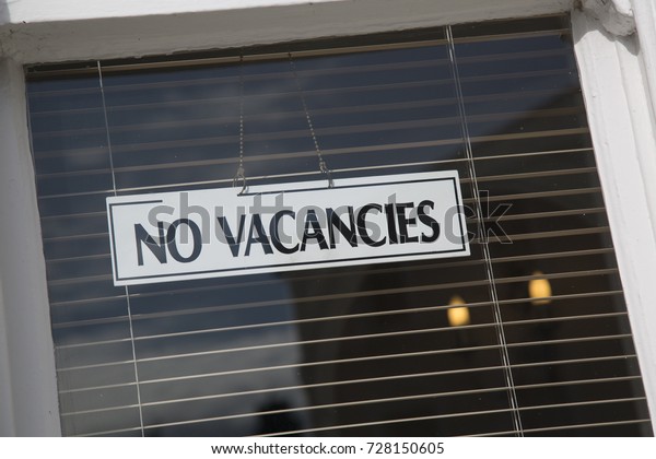 No Vacancies Hotal Sign on\
Window
