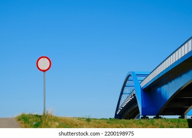 No Vehicles Traffic Road Sign And Bridge, Blue Railing, Clear Sky 