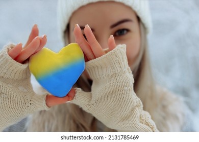 No war. February the beginning of the war in Ukraine the girl holds a heart of a pathetic blue color in her hands. Peace in Ukraine