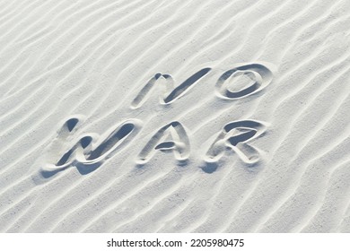 No War Written With Finger On White Sand, 