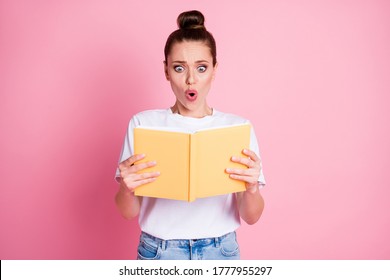 No way it cant be truth. Astonished woman read book impressed stunning information wear good look clothes isolated over pink color background
