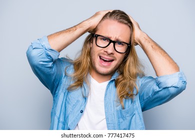 No Way! Close Up Portrait Of Very Upset, Unhappy Men In Glasses, Jeans Shirt Holding Hands On Head, Looking At Camera Over Grey Background