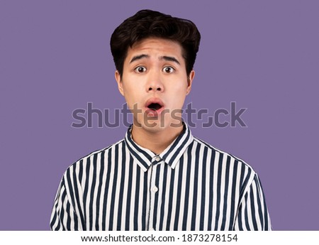 No Way. Closeup portrait of shocked and surprised asian guy looking at camera in amazement with open mouth, isolated over purple studio background. People, Human Emotions And Feelings Concept