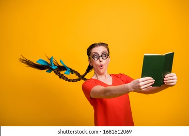 No way! Photo of funny student lady open mouth clever person hairdo flight read exciting book not believe eyes intrigue wear casual red t-shirt isolated vibrant yellow color background