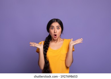 No Way. Portrait of excited surprised and amazed young indian lady looking at camera with open mouth and spreading hands, shocked woman can't believe her eyes, isolated over purple studio background - Shutterstock ID 1927698653