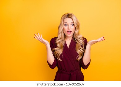 No way! Portrait of impressed shocked stupid woman with wide open eyes mouth long hair in burgundy suit, isolated on yellow background, looking at camera