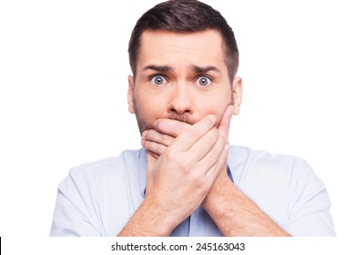 No Way! Shocked Young Man In Formalwear Covering Mouth With Hands And Looking At Camera While Standing Against White Background