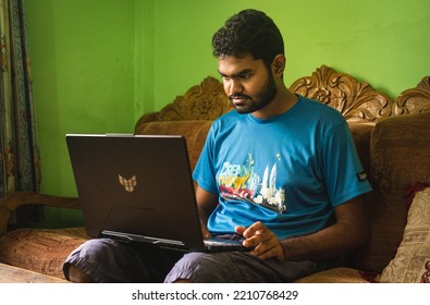 Noakhali, Bangladesh- September 30,2022 : South Asian Young Male Working With Laptop From Home. 