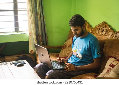 Noakhali, Bangladesh- September 30,2022 : South Asian Young Male Working With Laptop From Home. 