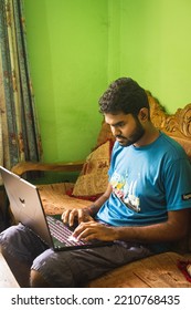 Noakhali, Bangladesh- September 30,2022 : South Asian Young Male Working With Laptop From Home. 