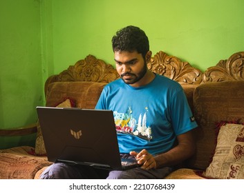 Noakhali, Bangladesh- September 30,2022 : South Asian Young Male Working With Laptop From Home. 