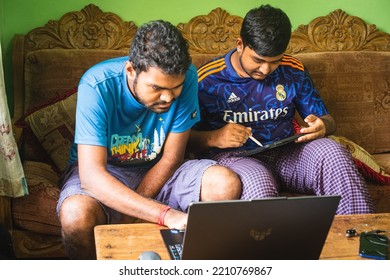 Noakhali, Bangladesh- September 30,2022 : South Asian Young Brothers Working With Laptop And Tablet From Home