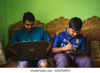 Noakhali, Bangladesh- September 30,2022 : South Asian Young Brothers Working With Laptop And Tablet From Home