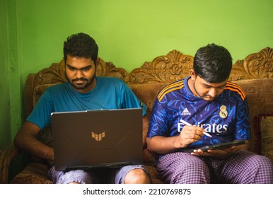 Noakhali, Bangladesh- September 30,2022 : South Asian Young Brothers Working With Laptop And Tablet From Home