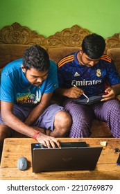 Noakhali, Bangladesh- September 30,2022 : South Asian Young Brothers Working With Laptop And Tablet From Home