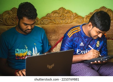 Noakhali, Bangladesh- September 30,2022 : South Asian Young Brothers Working With Laptop And Tablet From Home