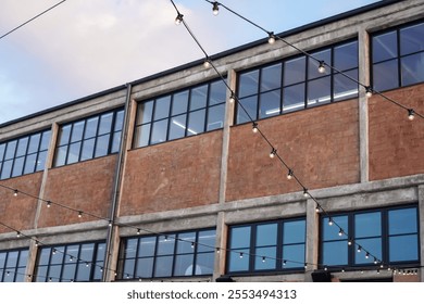 Noblessner area in Tallinn showcases a charming building adorned with string lights, reflecting the vibrant atmosphere of 2024. - Powered by Shutterstock