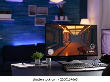 Nobody At Desk With Online Video Games On Computer To Play With Controller. Empty Room With Digital Game On Monitor, Modern Gaming Equipment And Device To Have Leisure Activity.