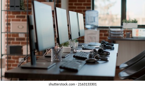 Nobody In Empty Call Center Workstation With Computers And Audio Instruments. No People At Customer Service Office Desks With Telecommunications Technology, Offering Helpline Assistance.