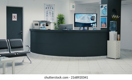 Nobody in hospital reception desk and waiting room at facility to attend medical consultation appointment. Waiting area lobby with chairs and counter at healthcare clinic, disease medicine. - Shutterstock ID 2168920341