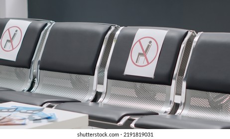 Nobody In Hospital Reception Lobby With Empty Chairs At Healthcare Clinic During Covid 19 Epidemic. No People Attending Checkup Visit Appointment At Facility Waiting Room, Virus Protection.