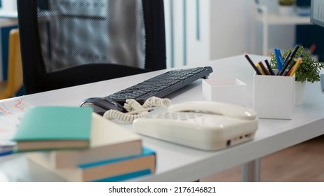 Nobody At Office Desk With Supplies And Startup Documents, Landline Phone And Financial Papers. No People In Empty Workplace To Work On Marketing Sales Statistics And Analysis. Close Up.