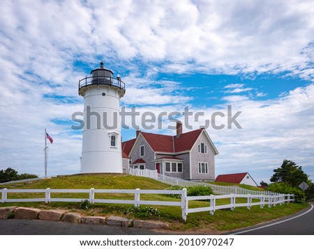 Nobska Light and Red Roof House in Woods Hole on Cape Cod, Massachusetts. American Landmark Lighthouse on the Green Garden Hill with Wild Plant Bushes in the Summer.