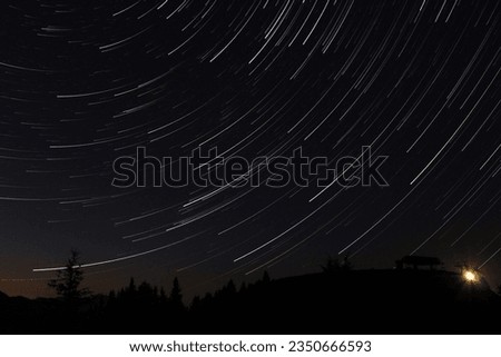 nocturnal alpine landscape with star trails