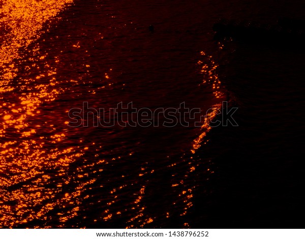 nocturnal reflections of colors in the sea water,\
reflections caused by the\
moon.