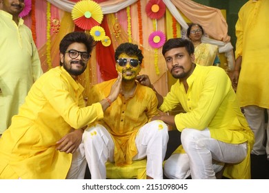 Noida, India 2022: Boys wearing yellow dress posing with groom for photographs. Haldi application is traditional rituals in Hindu wedding rituals 