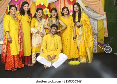 Noida, India 2022: Sisters Grouping Together And Teasing Their Brother During Haldi Ceremony. All Of Them Are Dressed In Yellow Clothes