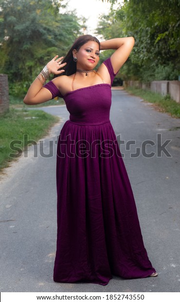 NOIDA, INDIA - SEPTEMBER 2020 : Young beautiful\
stylish Indian girl in colorful dress in studio. Designer dress\
shoot concept.