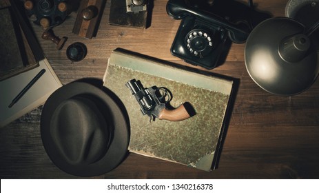 Noir 1950s Style Detective Vintage Desktop With Revolver, Fedora Hat And Telephone, Flat Lay