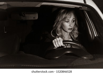 Noir Film. Young Confident Businesswoman Driving Car. City Concept



