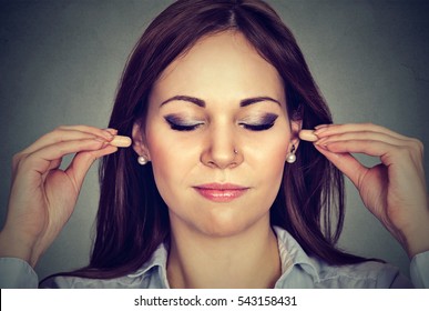 Noise Control. Young Woman With Ear Plugs Isolated On Gray Wall Background