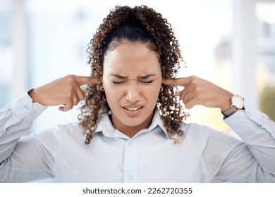 Noise, loud and woman closing her ears for the sounds in the office while working on a project. Annoyed, frustrated and upset professional female employee plug her fingers in her ear in the workplace - Powered by Shutterstock