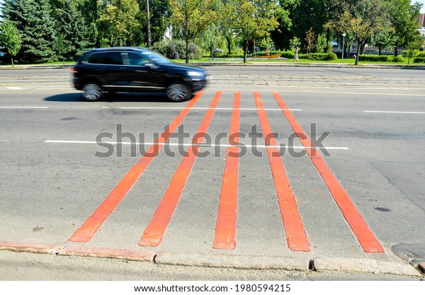 Noise stripes on a road in the city. The car\
drives along the noise\
lanes.