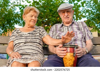 Noja, Spain, August 25, 2022: Elderly Matrimony Playing An African Drum Workshop. Music Therapy For Dementia