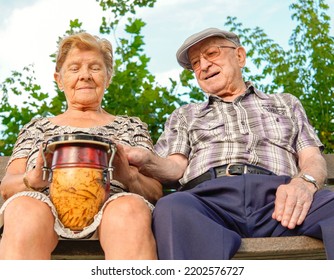 Noja, Spain, August 25, 2022: Elderly Matrimony Playing An African Drum Workshop. Music Therapy For Dementia