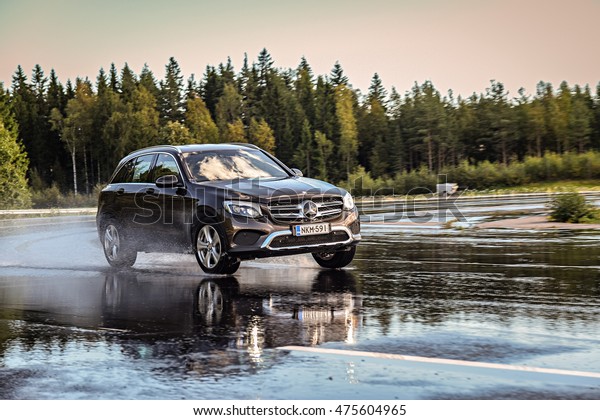 NOKIA, FINLAND - AUGUST 25, 2016: Summer tire test\
is held at the proving ground. Test-driver performs a wet handling\
test on Mercedes-Benz GLC to determine the tire which provides the\
best grip.