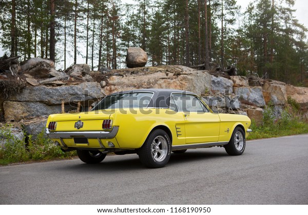 NOKIA, FINLAND - August 26: \
First generation Ford Mustang parked outdoor. Black vinyl roof.\
Muscle car from USA. Image taken in Nokia, Finland on August 26,\
2018.