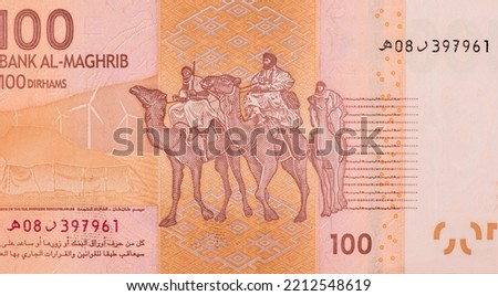 nomadic tribes of Southern Morocco. Moroccan tent in a desert during Tan-Tan Moussem. Wind turbines, wind farm, symbolizing renewable energy. Portrait from Morocco 100 Dirhams 2012 Banknotes.