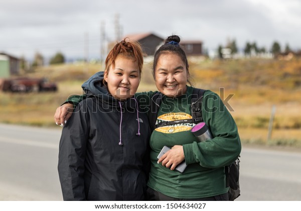 Nome, Alaska, USA - September 10th, 2019:\
Portrait of two native inuit - eskimos women looking camera,\
outdoors on Seppala Dr in Nome,\
Alaska.