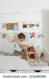 Non Binary Diverse Male Kid Playing Wooden Dolls House Enjoy Happy Childhood At Home Room Interior. Baby Boy Early Development Toy Game Girlish Plaything. Gender Individuality Freedom Choice Tolerance