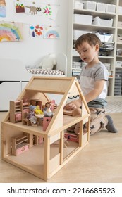 Non Binary Diverse Male Kid Playing Wooden Dolls House Enjoy Happy Childhood At Home Room Interior. Baby Boy Early Development Toy Game Girlish Plaything. Gender Individuality Freedom Choice Tolerance