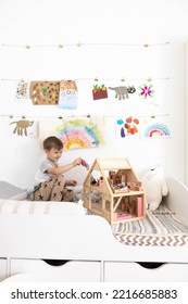 Non Binary Diverse Male Kid Playing Wooden Dolls House Enjoy Happy Childhood At Home Room Interior. Baby Boy Early Development Toy Game Girlish Plaything. Gender Individuality Freedom Choice Tolerance