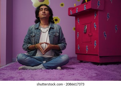 Non binary man doing yoga in his girly room. Mental health concept. - Powered by Shutterstock